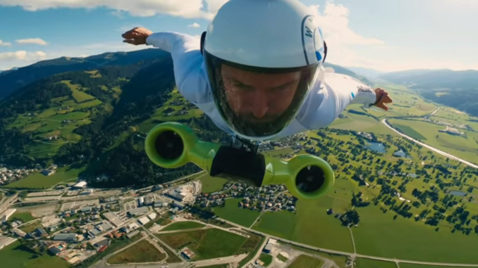 Austrian Peter Salzmann piloting his electric wingsuit. The electric portion, with ducted fans, is stapped to his chest.